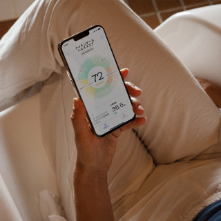 Person viewing My Nightingale health results on a smartphone, photograph.
