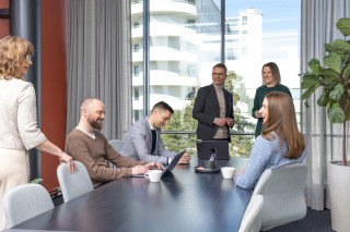 Team members collaborating during a meeting in a modern office, photograph.